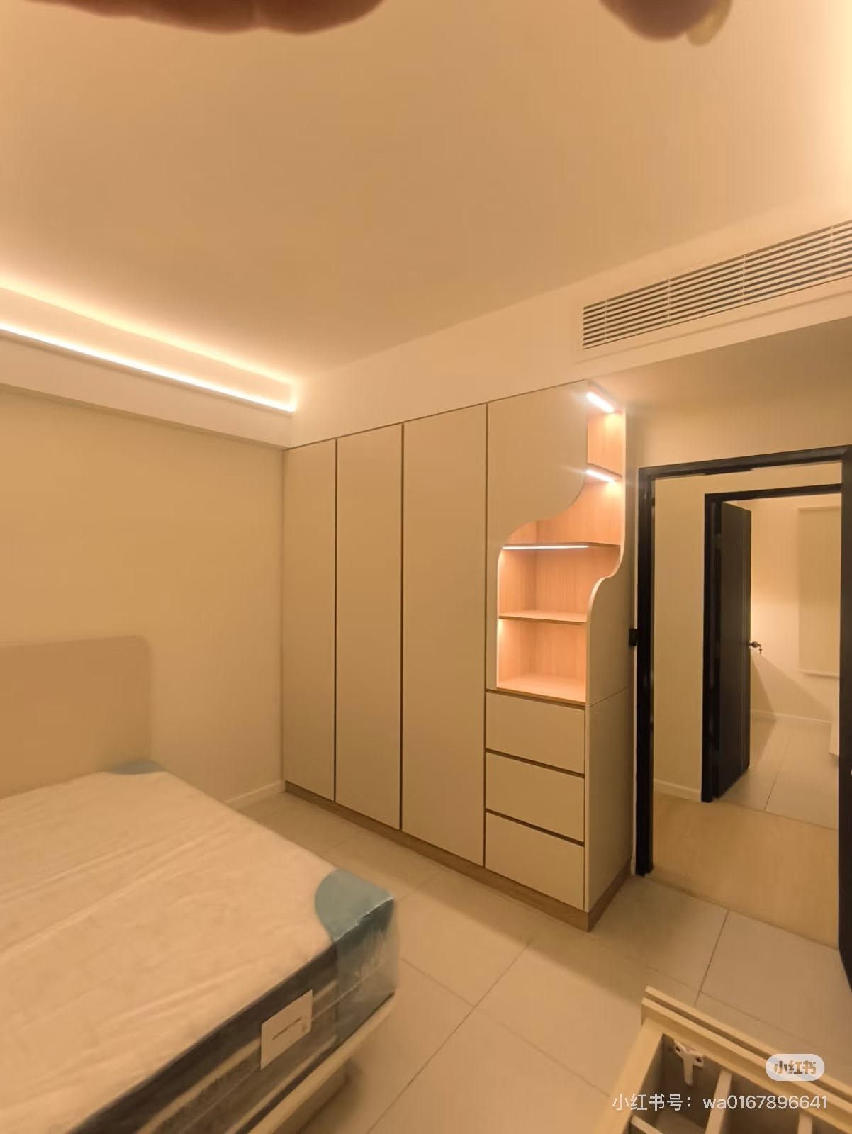 Bedroom with bespoke wardrobe and curved display shelving