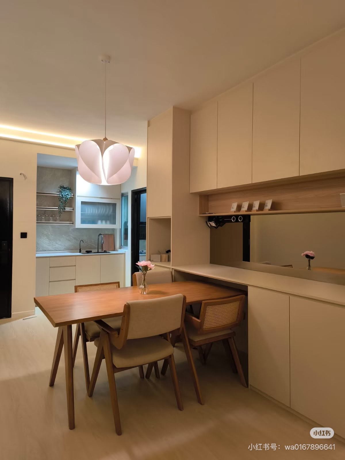 Dining area with bespoke joinery and sculptural pendant lighting